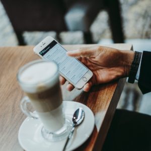 Guy Reading Phone Drinking Coffee