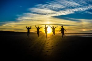 People Jumping at Sunset