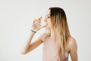 Photo by Karolina Grabowska: https://www.pexels.com/photo/young-woman-drinking-glass-of-cold-pure-water-4498234/ -- drink water